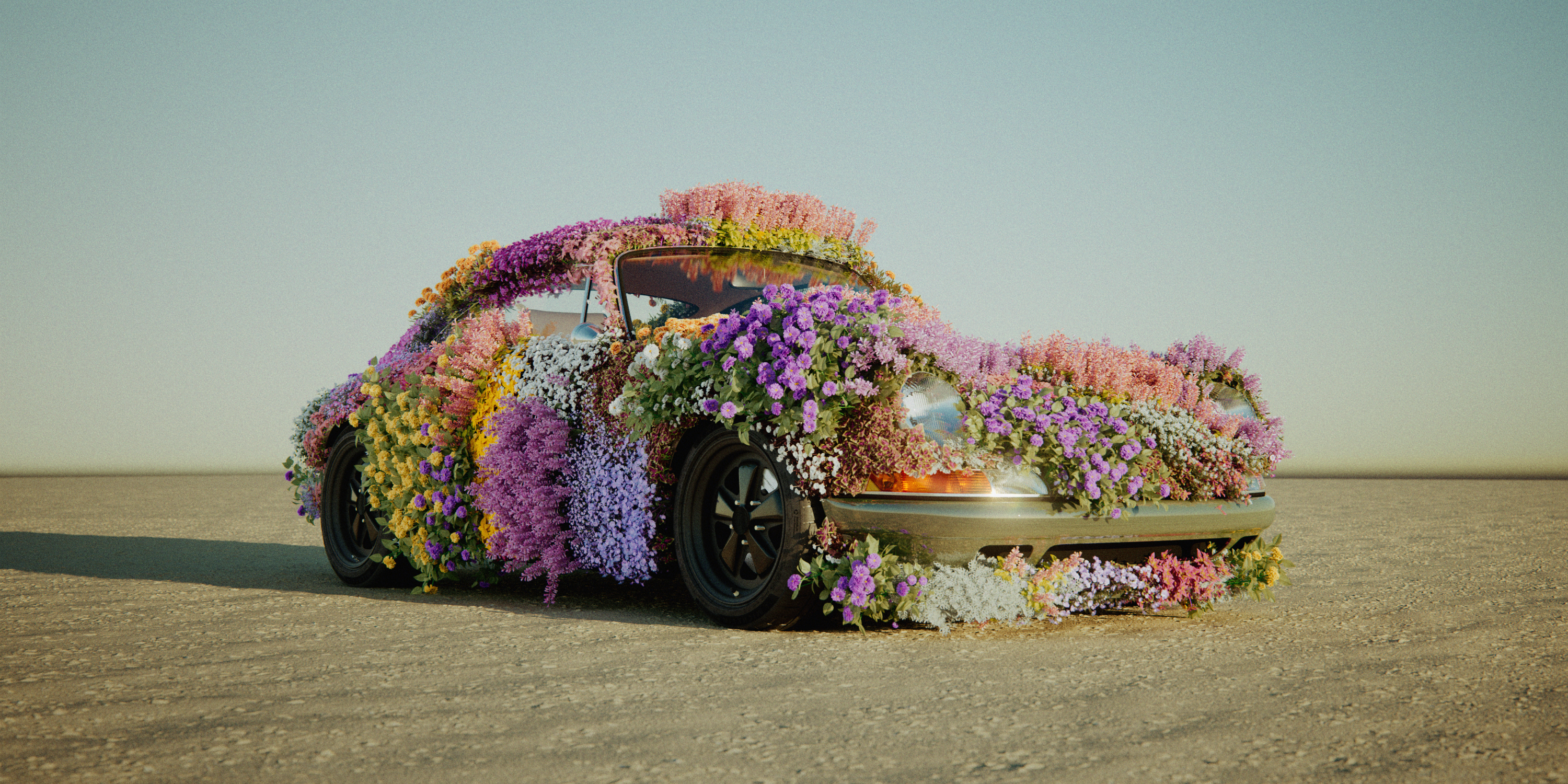 Porsche overgrown with flowers on a salt flat