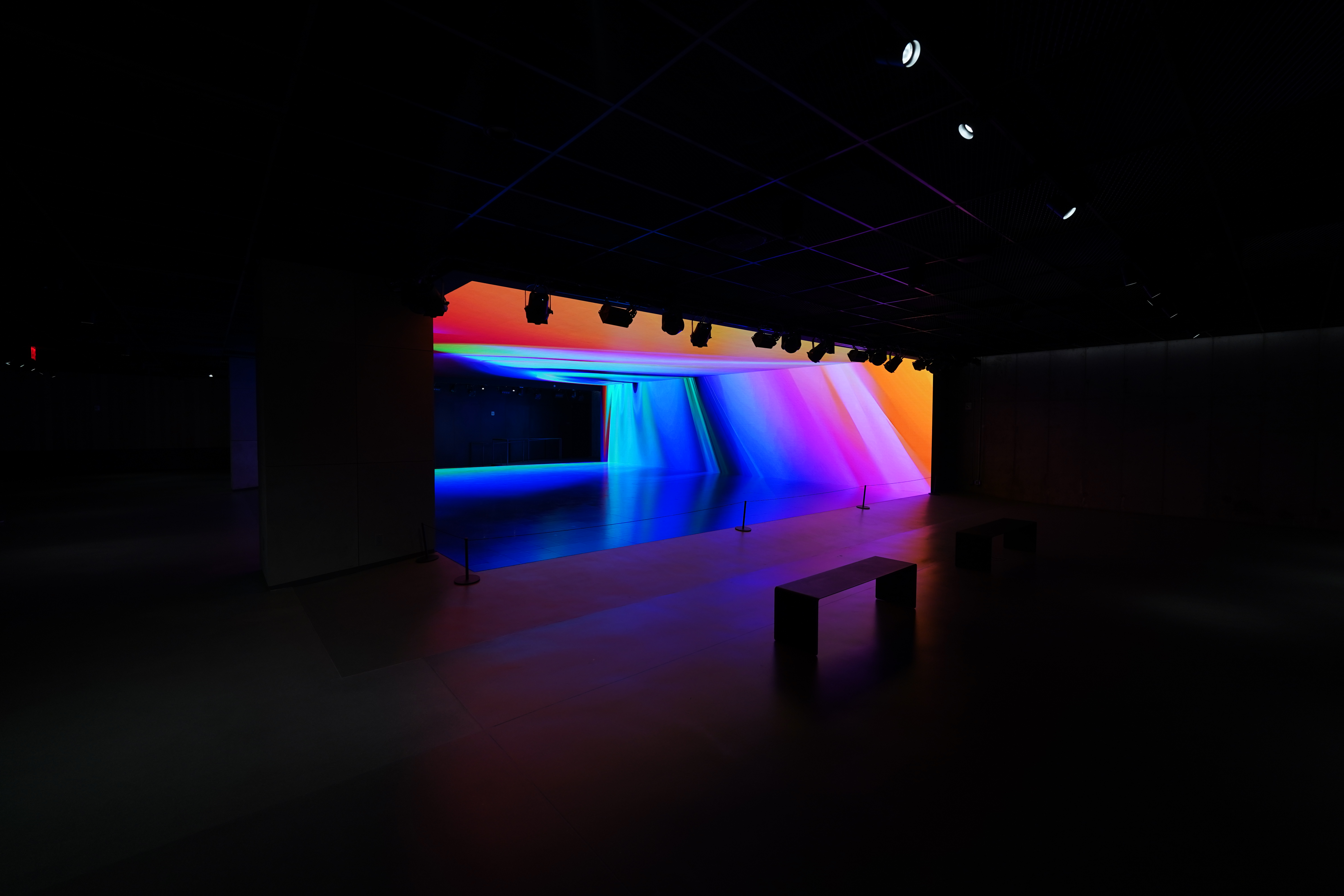 Spectrum of colour sweeping across the far wall