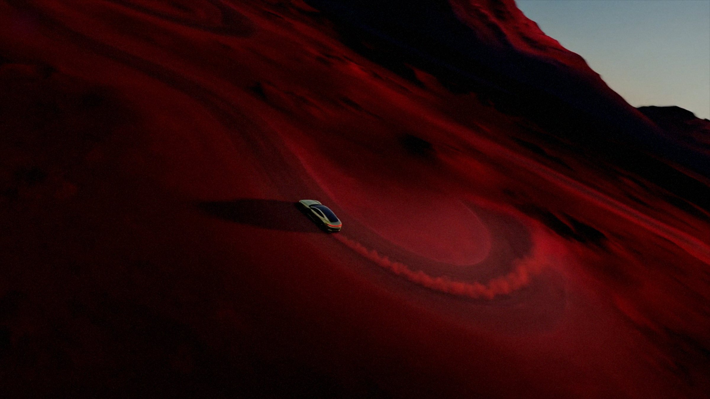Sedan trailing dust across red dunes